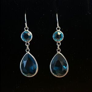 Handcrafted silver tone earrings with a blue colored stones.